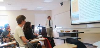 Summer Institute Director Dr. John Nicholson in classroom with students LATN 6050 
