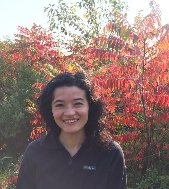 Photograph of Elizabeth Lavendar standing in front of a tree in the fall