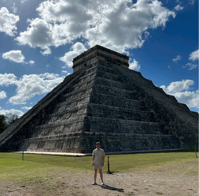 Teddy Starling standing inn fron of ancient architecture