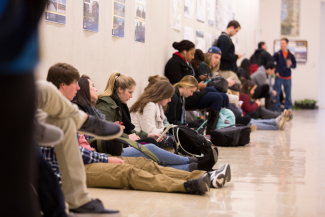 students sitting in hall waiting for class to begin